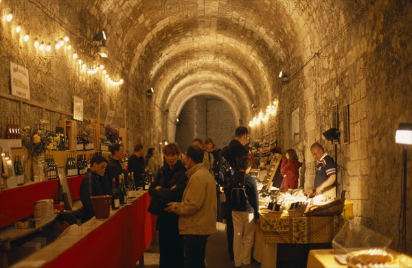 FRANCE, Loire Valley, Amboise, Indoor Wine Festival with people tasting at stalls.