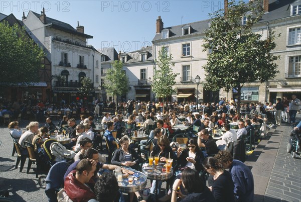 FRANCE, Loire Valley, Indre et loire, Tours Place Plumereau with view over people eating at tables and buildings behind.