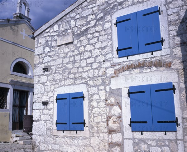 CROATIA, Rovinj, Old town church and cottage with blue painted shuttered windows