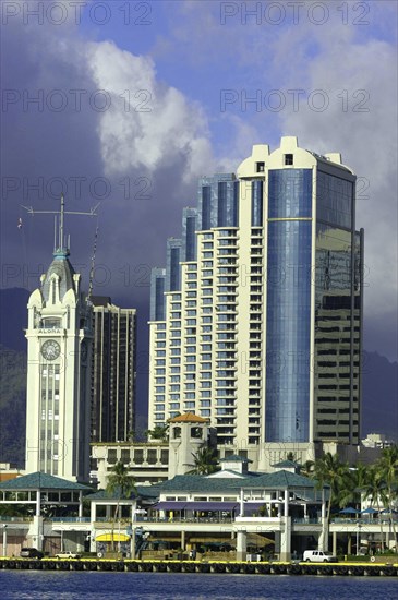 USA, Hawaii, Honolulu, Aloha Towers hotel seen over water