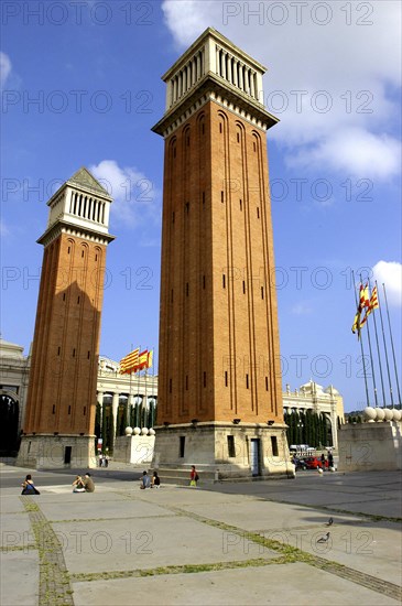SPAIN, Catalonia, Barcelona, Placa d Espanya. Angled view of the two 154ft high brick campaniles by Ramon Raventos.