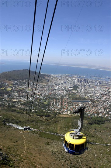 SOUTH AFRICA, Western Cape, Cape Town, Aerial view of cable car high above the city with views of the coastline beyond