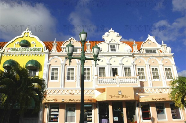 WEST INDIES, Dutch Antilles, Aruba, Oranjestad. Shop fronts with colonial style facades in pastel shades