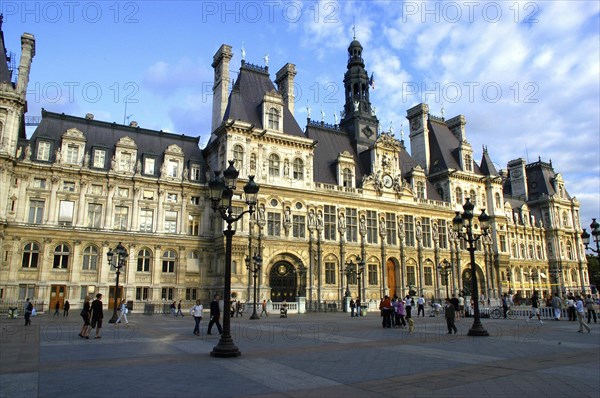 FRANCE, Ile de France, Paris, Hotel de Ville with elaborate turrets and stonework overlooking a pedestrianized square