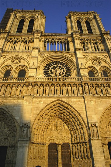 FRANCE, Ile de France, Paris, Angled view looking up at the west facade of the Notre Dame cathedral