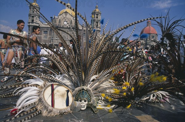 MEXICO, Mexico City, Our Lady of Guadaloupe Festival dancers outside the Basilica with feather head dresses on the ground