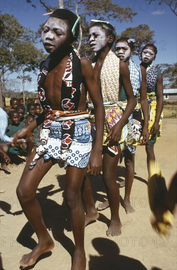 TANZANIA, Festivals, Makonde girls wearing ritual face whitening and dancing during female initiation ceremony.