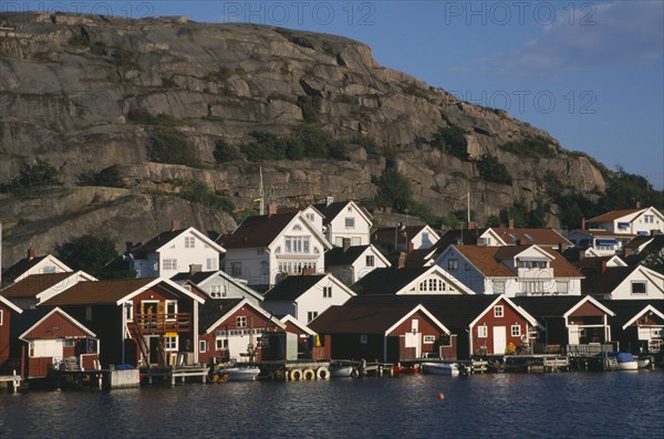 SWEDEN, Hunnebostrand, Traditional red painted houses beside the quay at the fishing village
