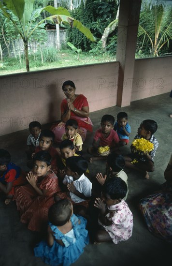 SRI LANKA, Kandy, Buddhist Temple class of infant children