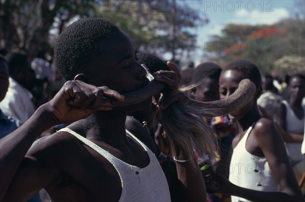 TANZANIA, Dodoma, Ngomas dancers using an animal horn as a musical instrument