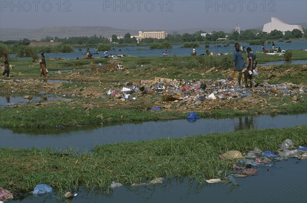 MALI, Bamako, View over the city across a rubbish tip and River Niger with people scavenging  amongst the waste.