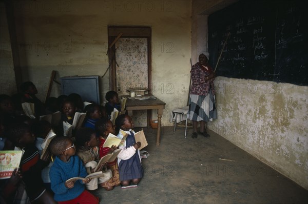 LESOTHO, Education, St Catherines School.  Classroom with pupils and teacher pointing to blackboard.