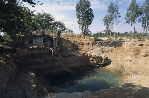 INDIA, Andhra Pradesh, Anantapur, Open dug well with electric pump irrigating dry area