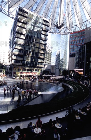GERMANY, Berlin, Potsdamer Platz. Sony complex interior with crowds gathered around central water fountain