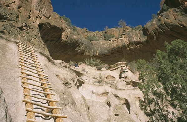 USA, New Mexico, Bandalier, Wooden ladder into Anasazi Indian cave dwelling in the national monument