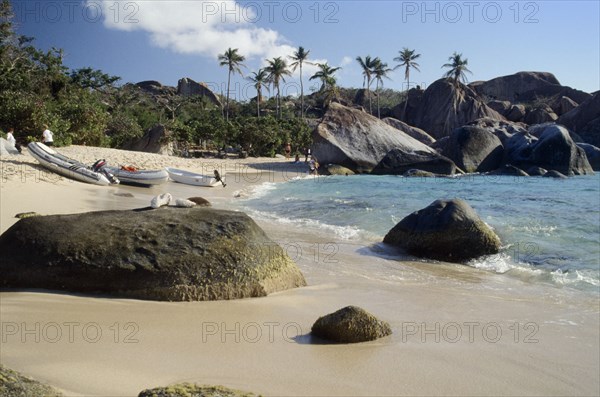 WEST INDIES, British Virgin Islands, Virgin Gorda, The Baths.  Quiet sandy beach with large boulders along shoreline.