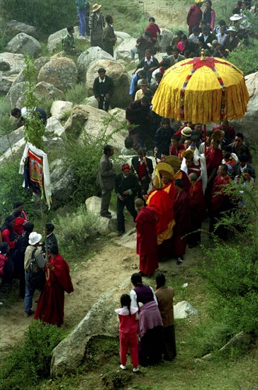 CHINA, Tibet, Drepung Monastery, Parade toward the Thangka and onlookers at a silken Thangka Buddhist ceremony for the cycle of life