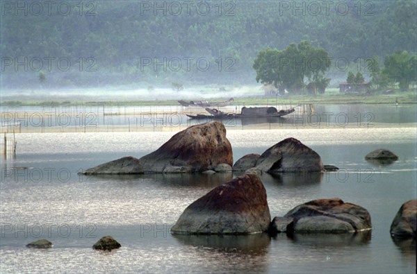 VIETNAM, Central, Lang Co, View over the rocky lagoon with passing boat