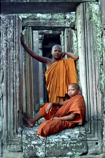 CAMBODIA, Angkor, The Bayon. Novice devotees posing among the temple ruins