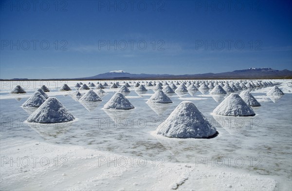 BOLIVIA, Uyuni, Salar de Uyuni, Salt flats with salt shovelled in to piles awaiting collection