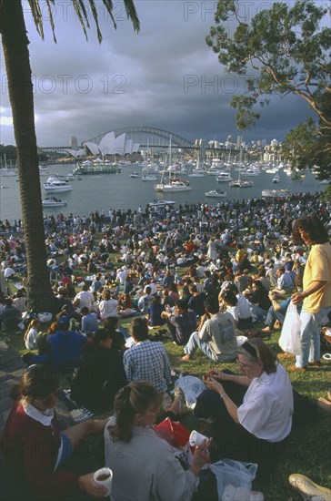 AUSTRALIA, New South Wales, Sydney, Crowds gathered at Mrs Macquaries Point to watch the New Years Eve fireworks display over Sydney Opera House and Harbour Bridge