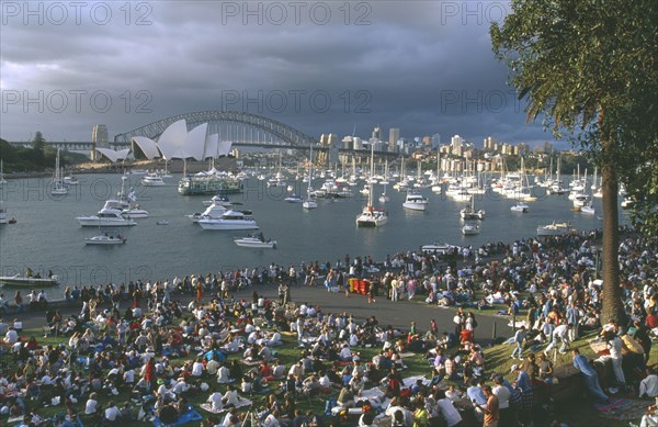 AUSTRALIA, New South Wales, Sydney, Crowds gathered at Mrs Macquaries Point to watch the New Years Eve fireworks display over Sydney Opera House and Harbour Bridge