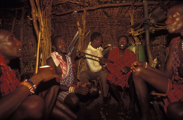 KENYA, , Maasai moran young warriors drinking milk during an initiation ceremony which brings them into manhood. The Maasai diet consists almost entirely of meat blood and milk.
