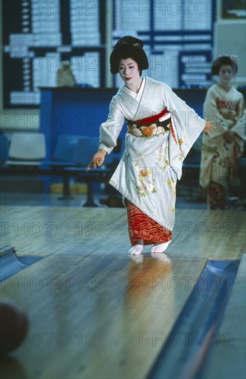 JAPAN, Honshu, Tokyo, Geisha girl in bowling alley.