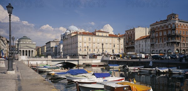 ITALY, Friuli-Venezia Giulia, Trieste, Grand Canale and iew over moored boats toward the waterfront architecture of the city