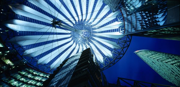 GERMANY, Berlin, Potsdamer Platz. View looking up from the interior of the glass roof of the Sony Centre illuminated at night