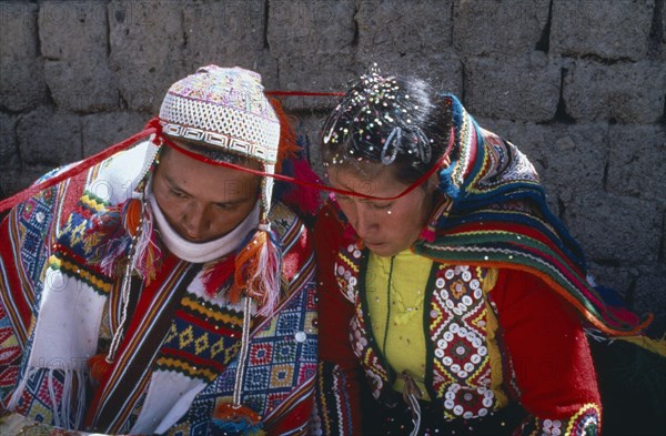 PERU, Cordillera, Vilcanota, Bride and groom during wedding ceremony encircled together with length of wool.
