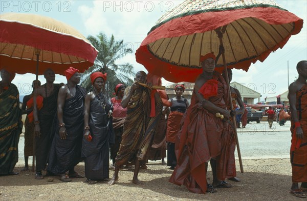 GHANA, Funeral, Ashanti tribe with umbrellas denoting office attending funeral.  Seen as a celebration a funeral typically lasts several days and is attended by the whole village.