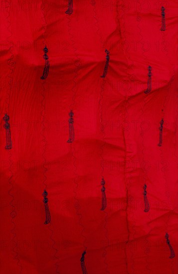 GHANA, Ashanti , Close up of traditional red Ashanti funeral cloth with pattern of swords.