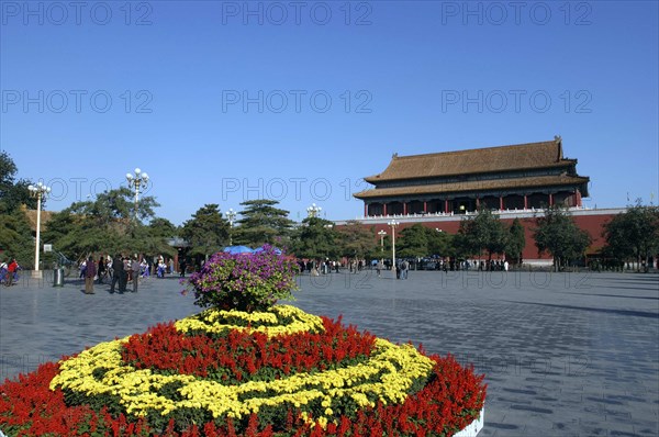 CHINA, Beijing, Forbidden City, View over flowerbed and courtyard outside the walls of the complex toward one of the buildings