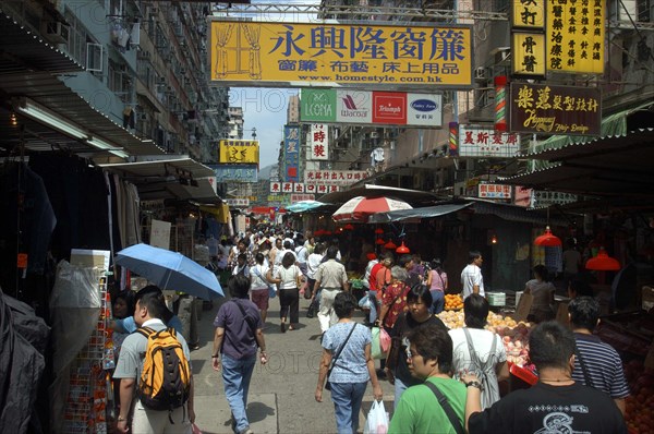 HONG KONG, General, Streetscene with shoppers and advertising banners overhead