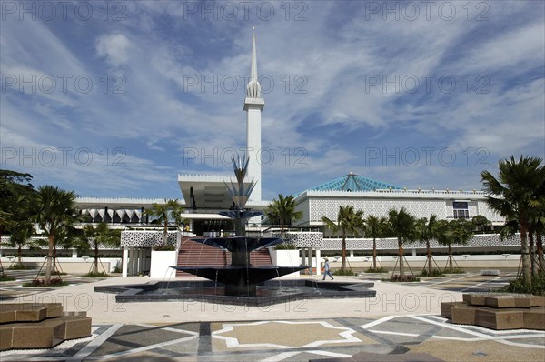 MALAYSIA, Kuala Lumpur, "Masjid Negara the National Mosque has a capacity of 15,000 people and is situated among 13 acres of beautiful gardens. The original structure was designed by a three-person team from the Public Works Department - UK architect Howard Ashley, and Malaysians Hisham Albakri and Baharuddin Kassim. Originally built in 1965, it is a bold and modern approach in reinforced concrete, symbolic of the aspirations of a then newly-independent Malaysia"