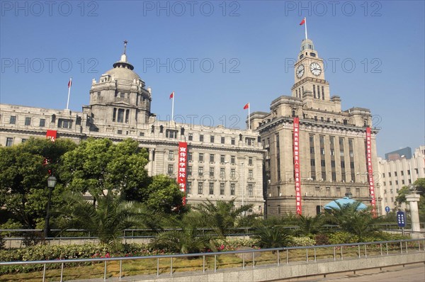 CHINA, Shanghai, The Bund aka Zhong Shan Road. View of the 1930s style waterfront architecture with clock tower and domed building