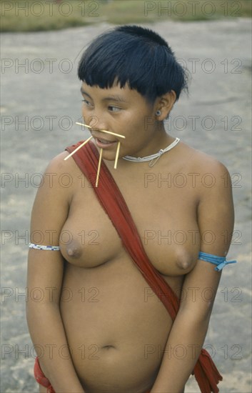 BRAZIL, Roraima, Amazon, Portrait of Yanomami woman with facial piercings.