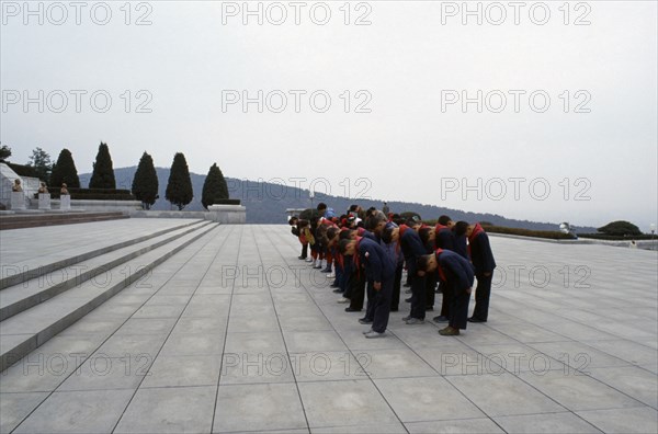 NORTH KOREA, Pyongyang, Group of children paying their respects at the Tomb of the Martyrs outside the city.