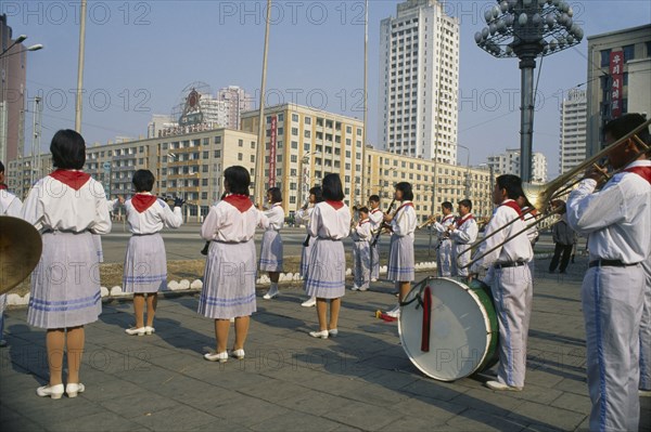 NORTH KOREA, Pyongyang, Juche ideology.  Band playing outside the railway station to encourage workers and travellers.