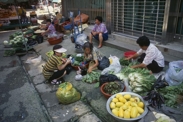 SOUTH KOREA, Kangwon, Sokcho, Women street vendors selling fruit and vegetables and kimchi in east coast fishing port.
