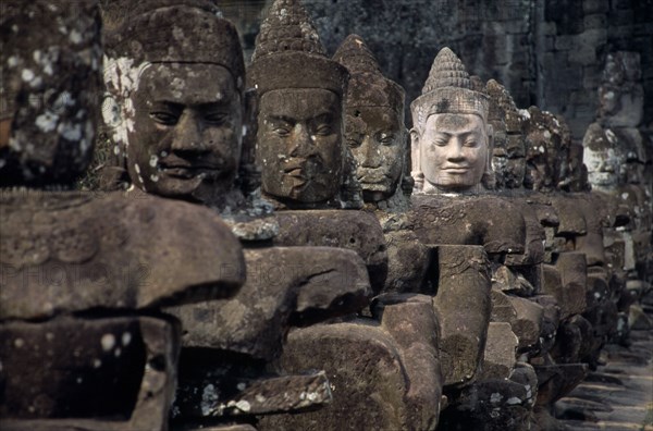 CAMBODIA, Siem Reap, Angkor Thom, South Gate causeway lined with statues of various gods the paler faced one recently restored