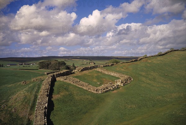 ENGLAND, Northumberland, Hadrians Wall, Cawfields Milecastle along section of ruined wall over Whin Sill crag