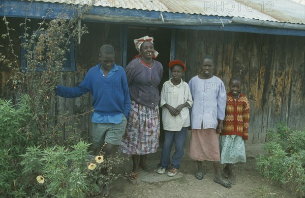 KENYA, Families, Portrait of rural family standing outside house near Bomet.