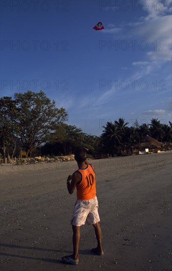 THAILAND, Krabi, Koh Lanta Yai, Klong Dao beach with a man on the sand flying a kite