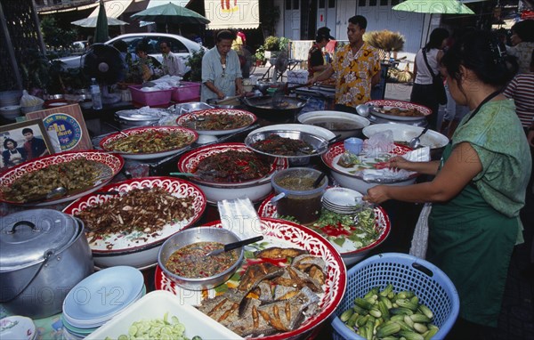THAILAND, South, Bangkok, Thanon Maharat beside The Imperial Palace with food stall selling cooked meals