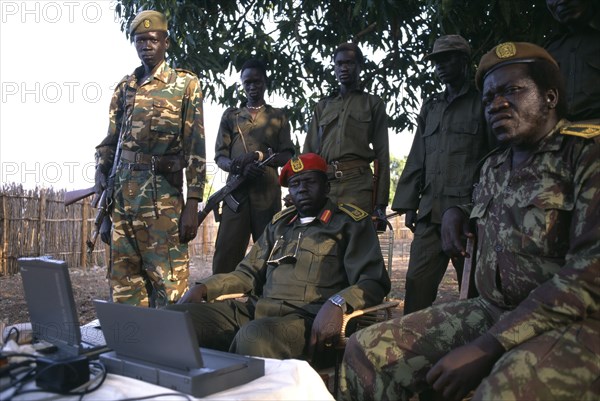 SUDAN, Marida, Commander Geia of the SPLA army sat down surrounded by soldiers with a lap top computer on the table in front of him.