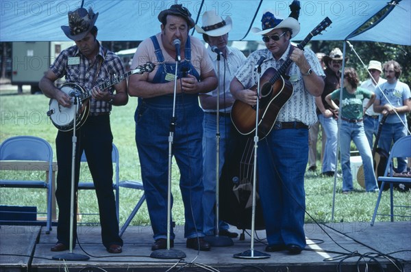 USA, West Virginia, Fort Vienna, Country and Western band playing on stage under blue tent.