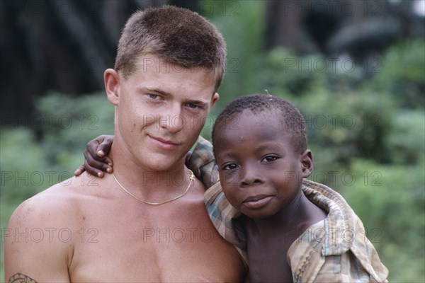 CAMEROON, Mundemba, British soldier holding Korup boy.