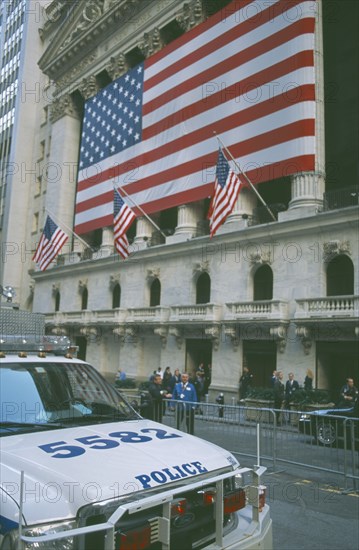 USA, New York, Manhattan, The Stock Exchange on Wall Street with columns draped with Stars and Strpes flag